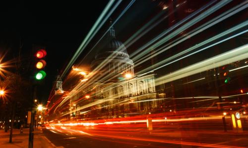 Night-time image of a busy road and traffic lights in a city 