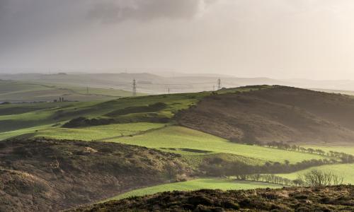 Transmission lines traversing green countryside - used for National Grid Hinkley Connection archaeological finds story