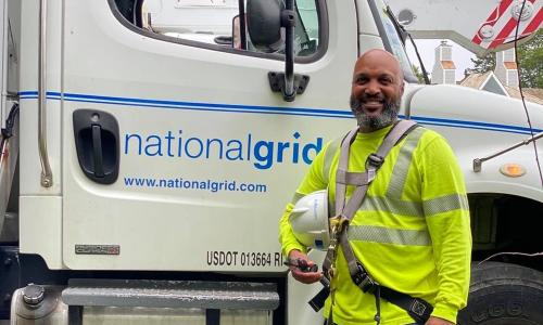 US Lineworker Donald Lopes in front of National Grid bucket truck