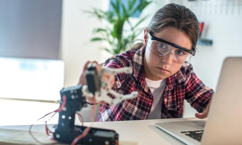 Young girl working with robotics for National Grid 'Inspiring female engineering talent story' for INWED