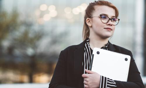 Young woman holding laptop used for National Grid US virtual internships story