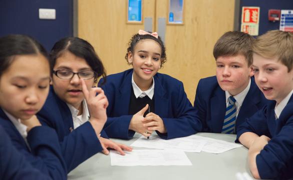 Young students sitting around a table