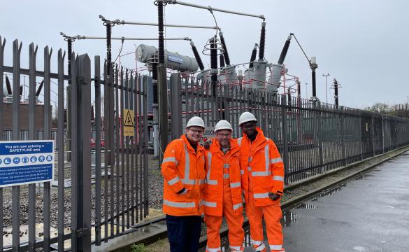 Three people at a substation in PPE