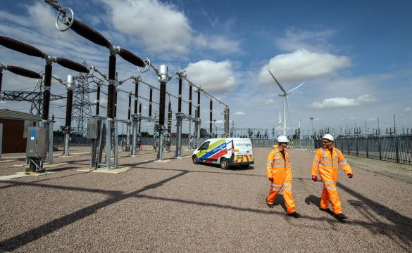 Workers walking near substation