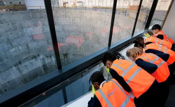 School pupils in PPE look into one of the LPT tunnel shafts