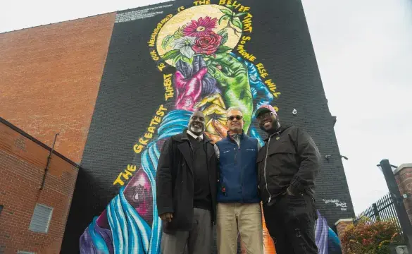 Group of people in front of wall art