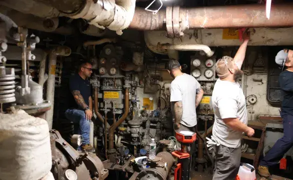 Employees working inside engine room