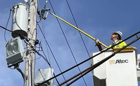 A Person repairing the Electric Pole