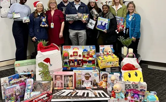 A Team of People Standing in front of Gifts