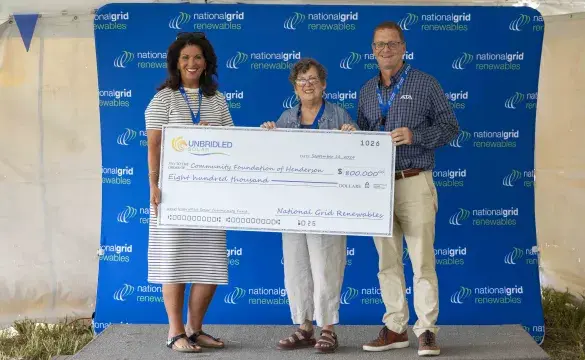 Team presenting donation check for solar project