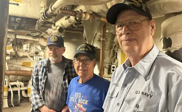 Dennis Yerkes, John Landwehr and Wallace Cardwell all served on the USS Little Rock and return each year to volunteer with ship maintenance. They took time from working in the newly lit engine room to discuss their friendship and share memories.  