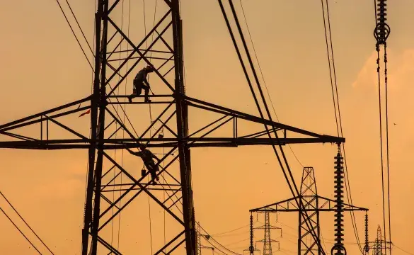 A pylon being refurbished at sunset