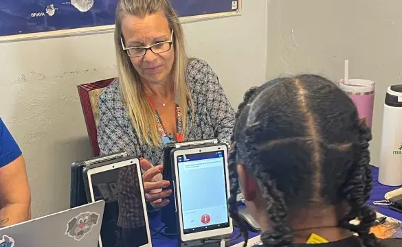 A National Grid customer advocate using TranslateLive to communicate with a customer at a recent event in Brockton, Mass., on Thursday, August 27, 2026. 