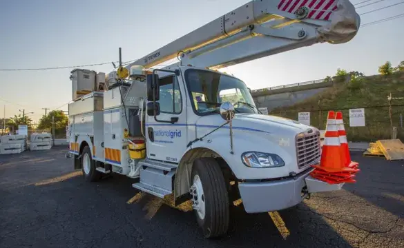 A National Grid truck parked in a Massachusetts facility utility work yard, ready to respond to potential storm damage.
