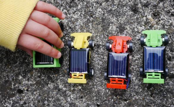 Child playing with toy cars
