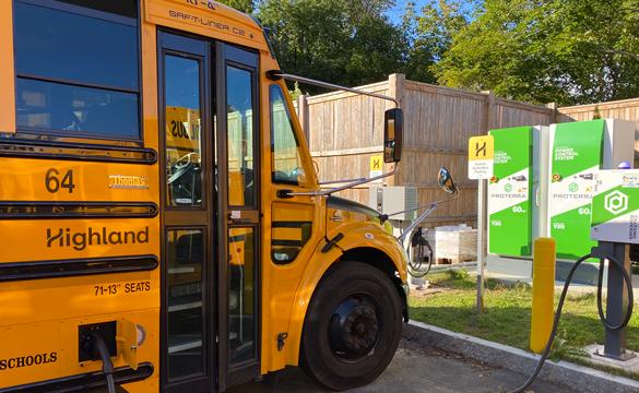 Yellow electric school bus at charging station in Beverly, Massachusetts