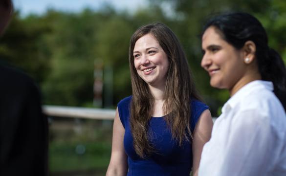 Two National Grid employees standing outside against a green background - Our people