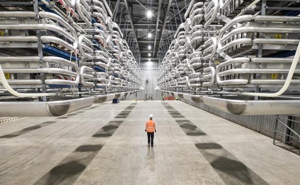 Engineer wearing PPE standing in the valve hall of the IFA2 interconnector