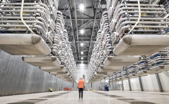 Engineer wearing PPE standing in the valve hall of the IFA2 interconnector