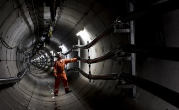 National Grid engineer inspecting the inside of a metallic tunnel structure