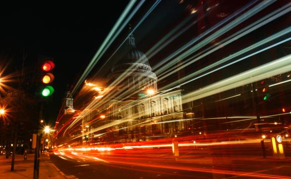 Night-time image of a busy road and traffic lights in a city