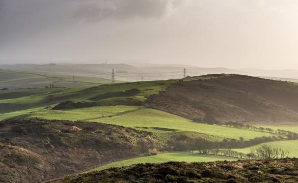 Transmission lines traversing green countryside - used for National Grid Hinkley Connection archaeological finds story