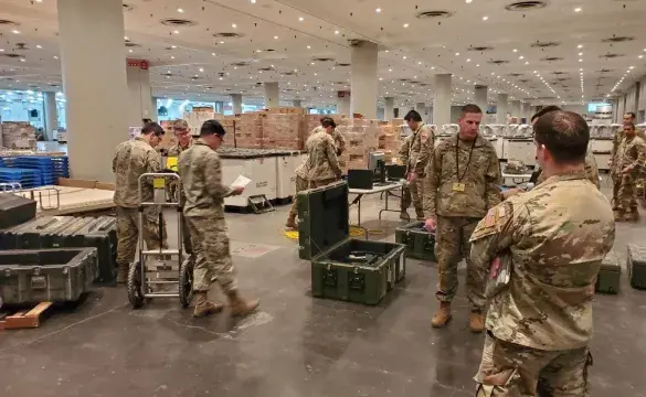 US military personnel in warehouse serving for National Guard - used for 'From National Grid to National Guard' story