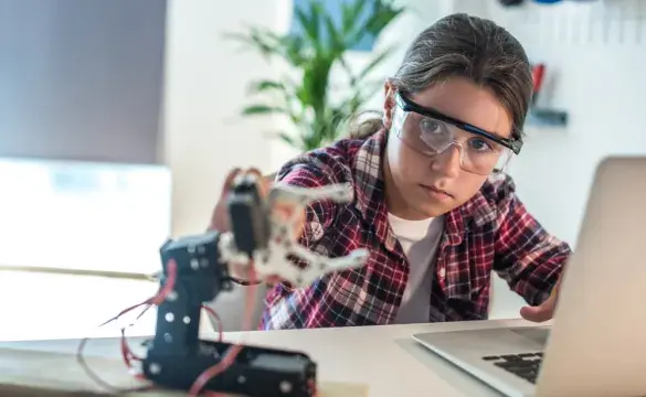 Young girl working with robotics for National Grid 'Inspiring female engineering talent story' for INWED