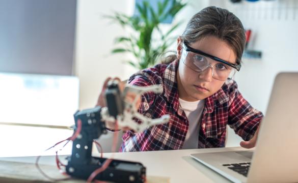 Young girl working with robotics for National Grid 'Inspiring female engineering talent story' for INWED