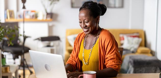 Woman smiling, working on computer