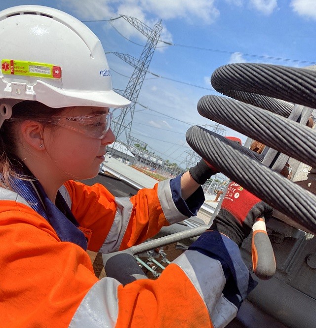 Alyssa Blackledge apprentice wearing PPE working on high-voltage power cables