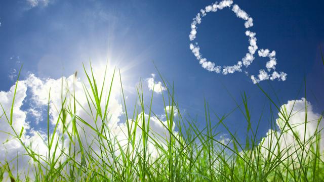 O2 (carbon dioxide) cloud formation in blue sky over green grass