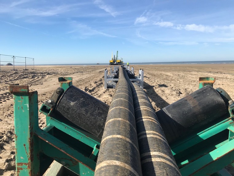 Interconnector cables being pulled across a beach - used for the National Grid article 'Connecting electricity systems for a greener Britain'