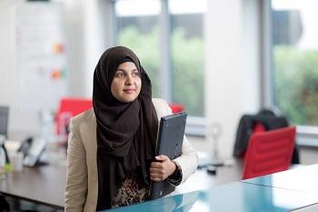 Jagriti Pala holding a file in an office.