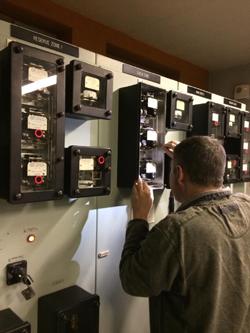 Man standing in front of electric measuring instruments - used for the National Grid story 'Keeping the lights on for London'