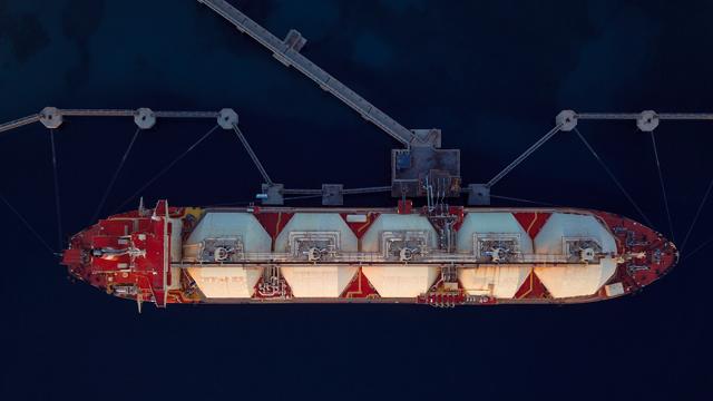 Overhead aerial shot of LNG tanker moored to a jetty