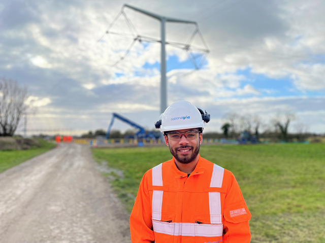 Lewis Prescod apprentice wearing PPE with T-pylon in the background