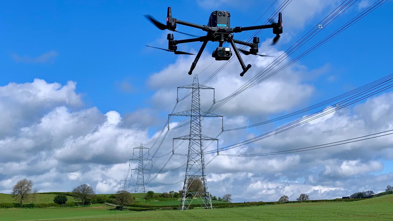 Drone inspecting high-voltage overhead power lines