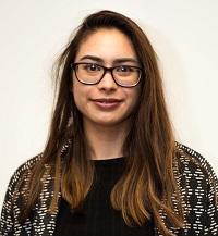 Young woman engineer with glasses smiling into camera