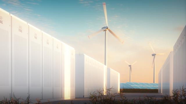 Rows of renewable energy storage batteries with wind turbines and solar panels in the background