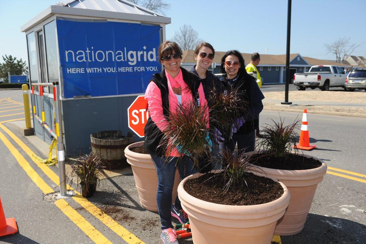 U.S. National Grid colleagues volunteering in the community planting tubs