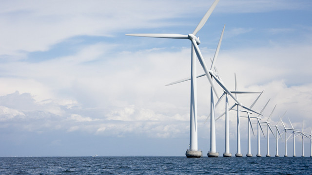 A line of wind turbines at sea
