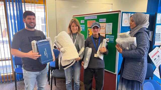 People at the Derby Refugee Advice Centre holding warm packs bough by grant from National Grid