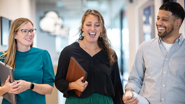 National Grid colleagues walking together in the office