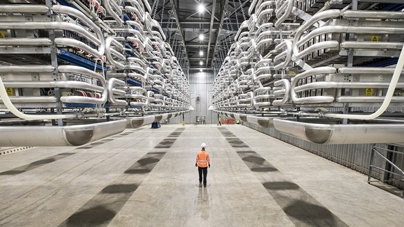 Engineer wearing PPE standing in the valve hall of the IFA2 interconnector