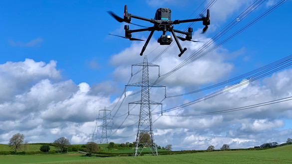 Drone inspecting high-voltage overhead power lines