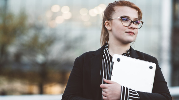 Young woman holding laptop used for National Grid US virtual internships story