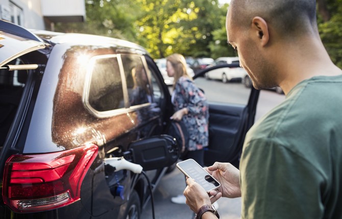 Black EV being charged and payment