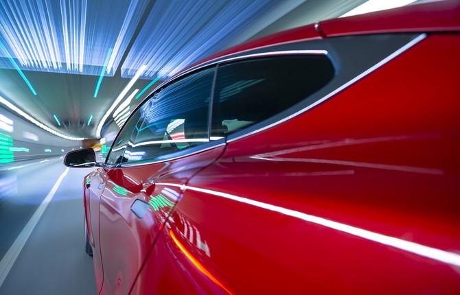 Red EV at speed through tunnel for National Grid article