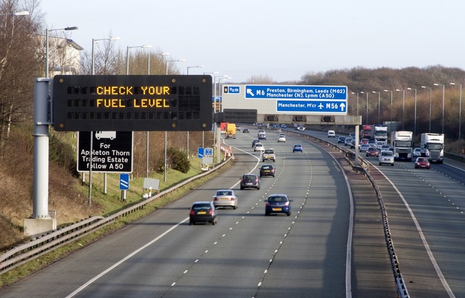 Motorway with 'check your fuel' sign for National Grid EV article